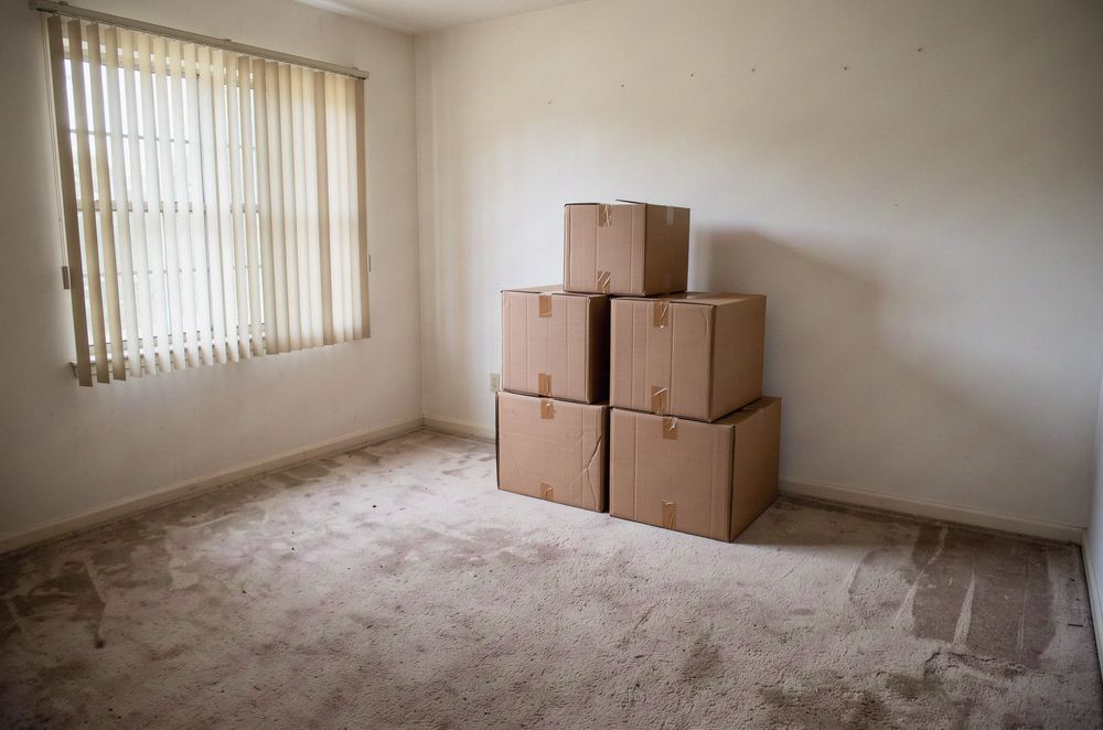 Moving boxes stacked in an empty room